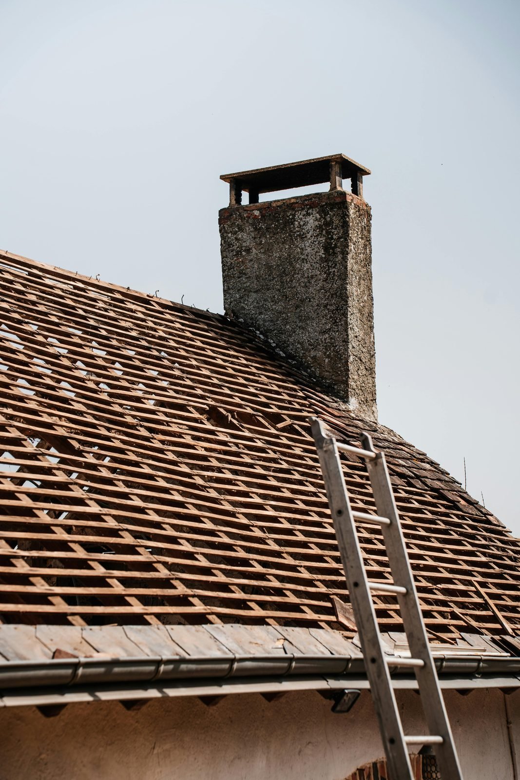 Roof stripped back showing battens — re-roofing in progress
